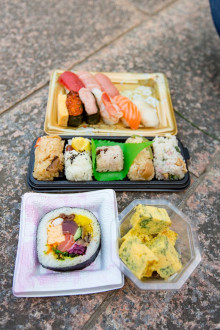 Nigirizushi set, mixed rice, a futomaki piece, and tamago negi