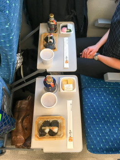 Breakfast on the train: onigiri, miso shiru, tamago, pickles, and Boss coffee