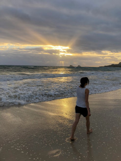 Kristan walks at sunrise on Kalama Beach