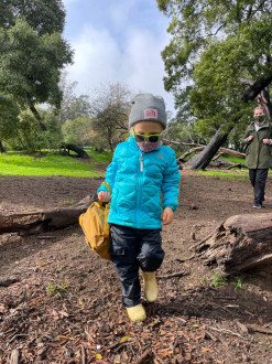 Cool kid coming home from preschool in the park